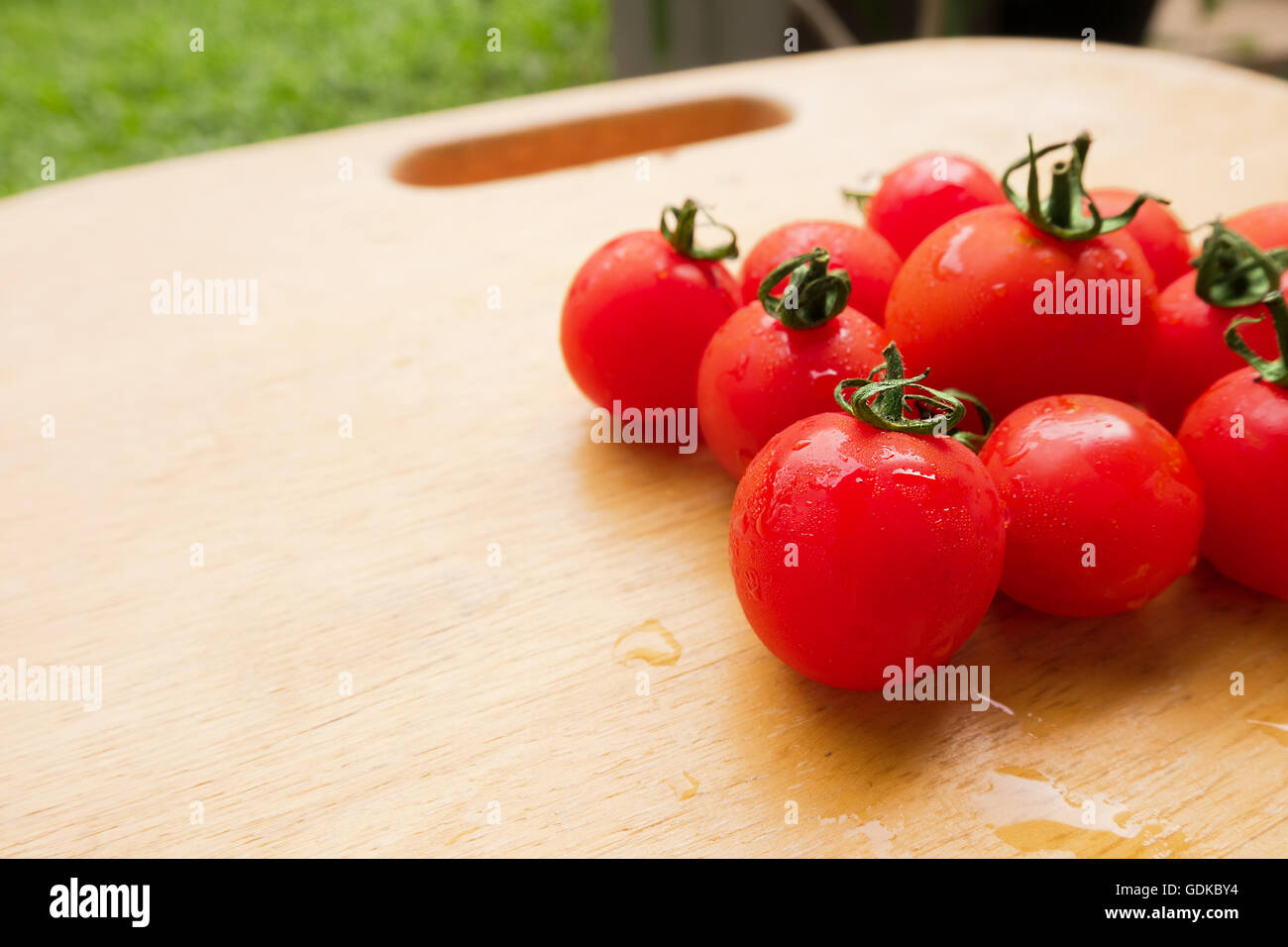 Tomate cerise frais groupe sur planche en bois. Banque D'Images