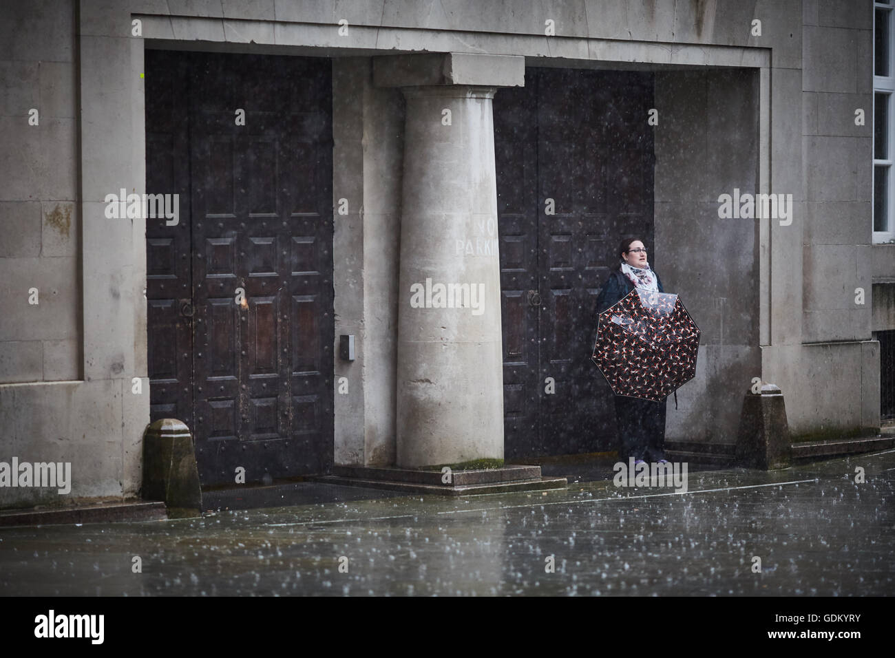 De fortes pluies dans le centre-ville de Manchester pleuvent pour trempage humide imbibé de parapluie en marbre pavement spay mi Banque D'Images