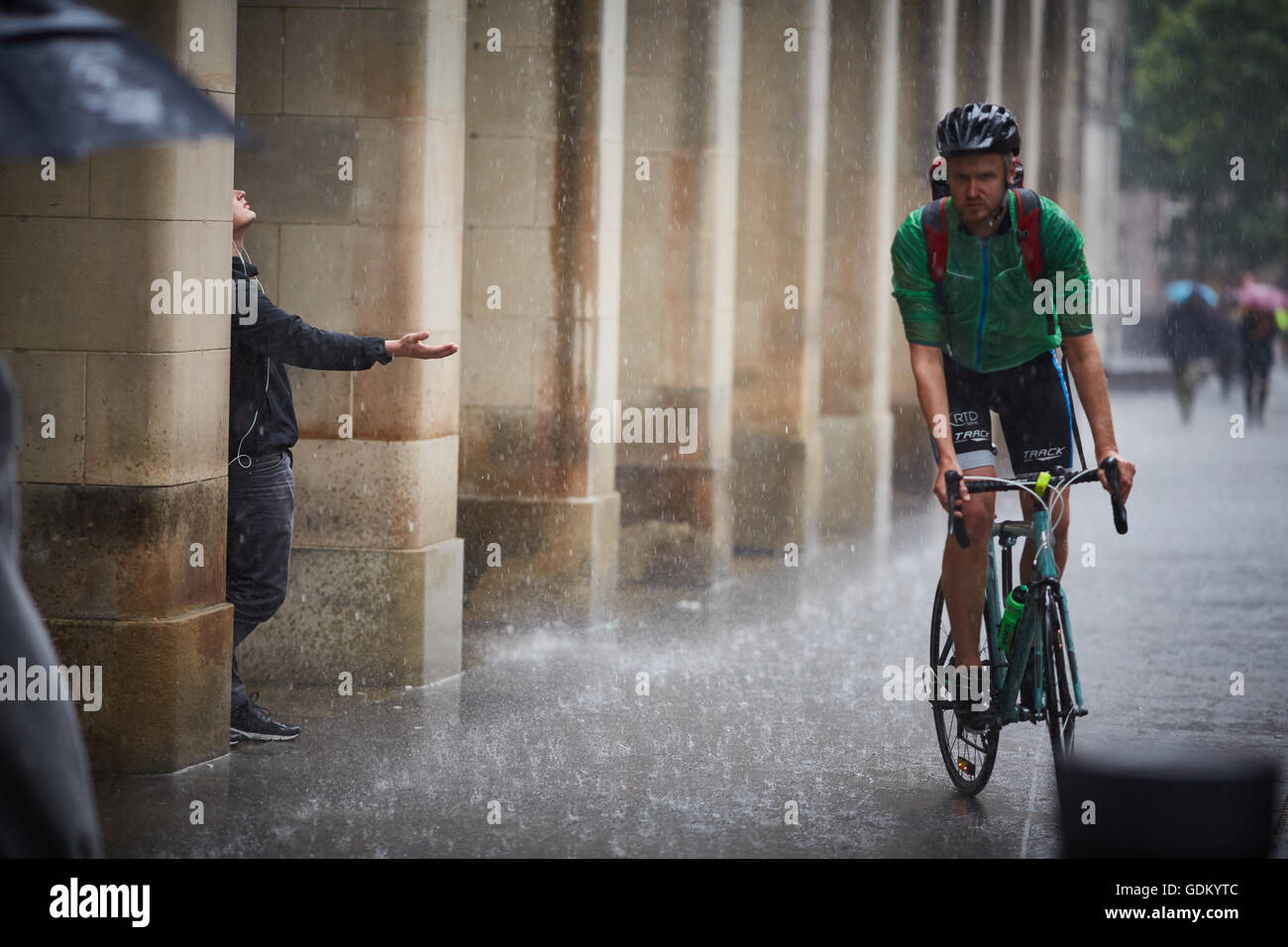 De fortes pluies dans le centre-ville de Manchester pleuvent pour trempage humide imbibé de parapluie en marbre pavement spay mi Banque D'Images