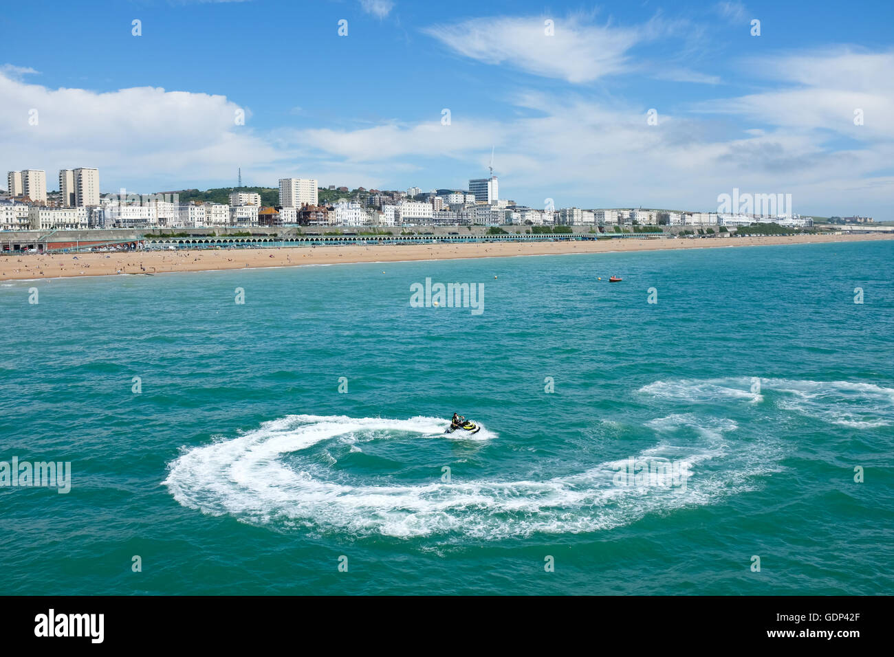 Un jet ski juste à côté du Palace Pier de Brighton sur la côte sud de l'Angleterre. Banque D'Images