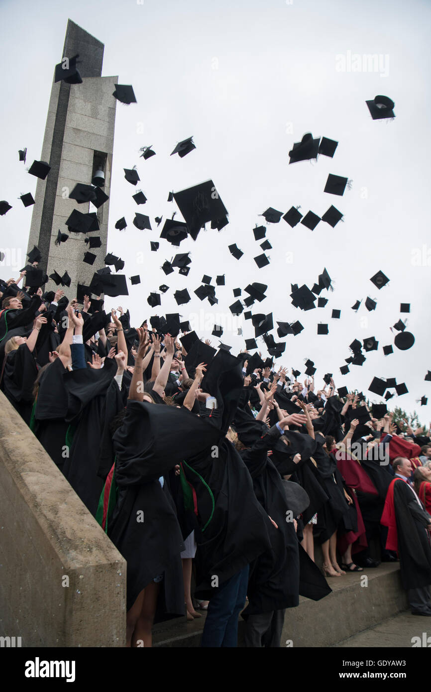 L'enseignement supérieur au Royaume-Uni : les étudiants de l'université d'Aberystwyth portant des robes traditionnelles, capes et bouchons jeter leurs cartes de mortier dans l'air de la manière traditionnelle fête leur diplôme lors de la cérémonie du jour, Juillet 2016 Banque D'Images