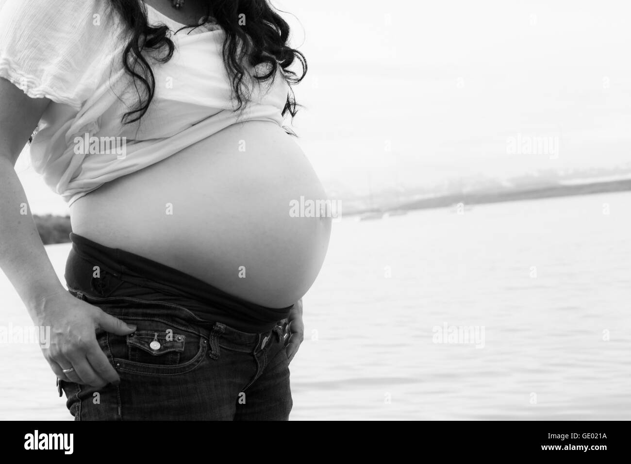 Pregnant woman standing at lakeside, Ammersee, Upper Bavaria, Bavaria, Germany Banque D'Images