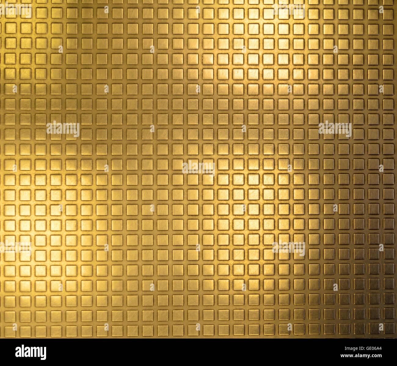 Métal plaqué or brillant avec une texture de surface sous la forme de petits carrés convexe Banque D'Images