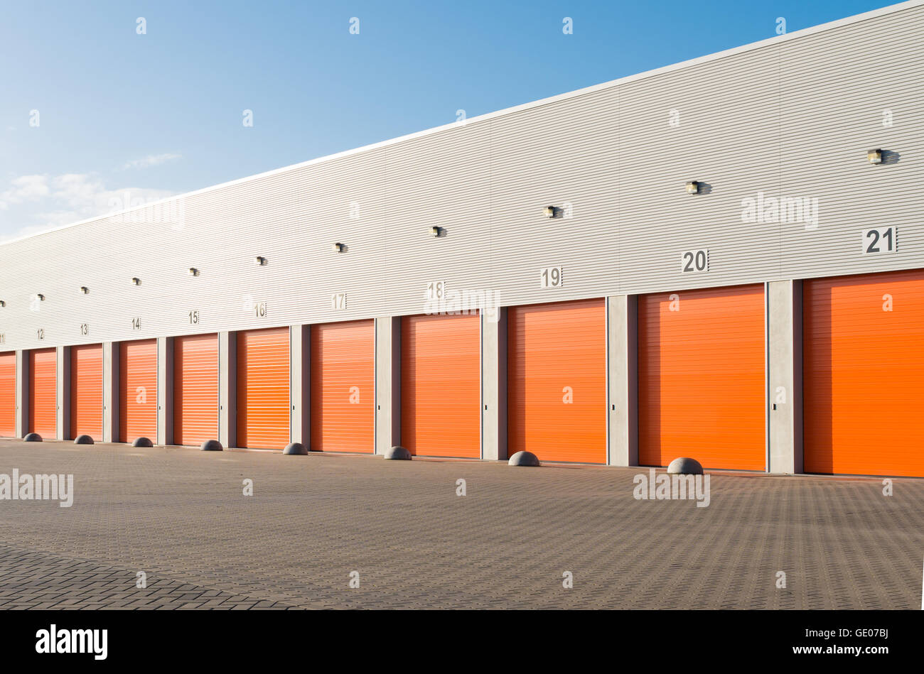 Extérieur d'un entrepôt commercial avec Orange portes à rouleaux Banque D'Images