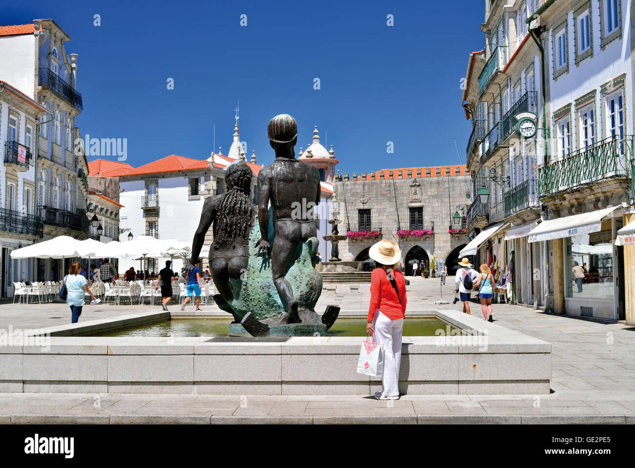 Le Portugal, Viana do Castelo : Femme avec chapeau et chemise rouge à la place principale à Praça da República Banque D'Images