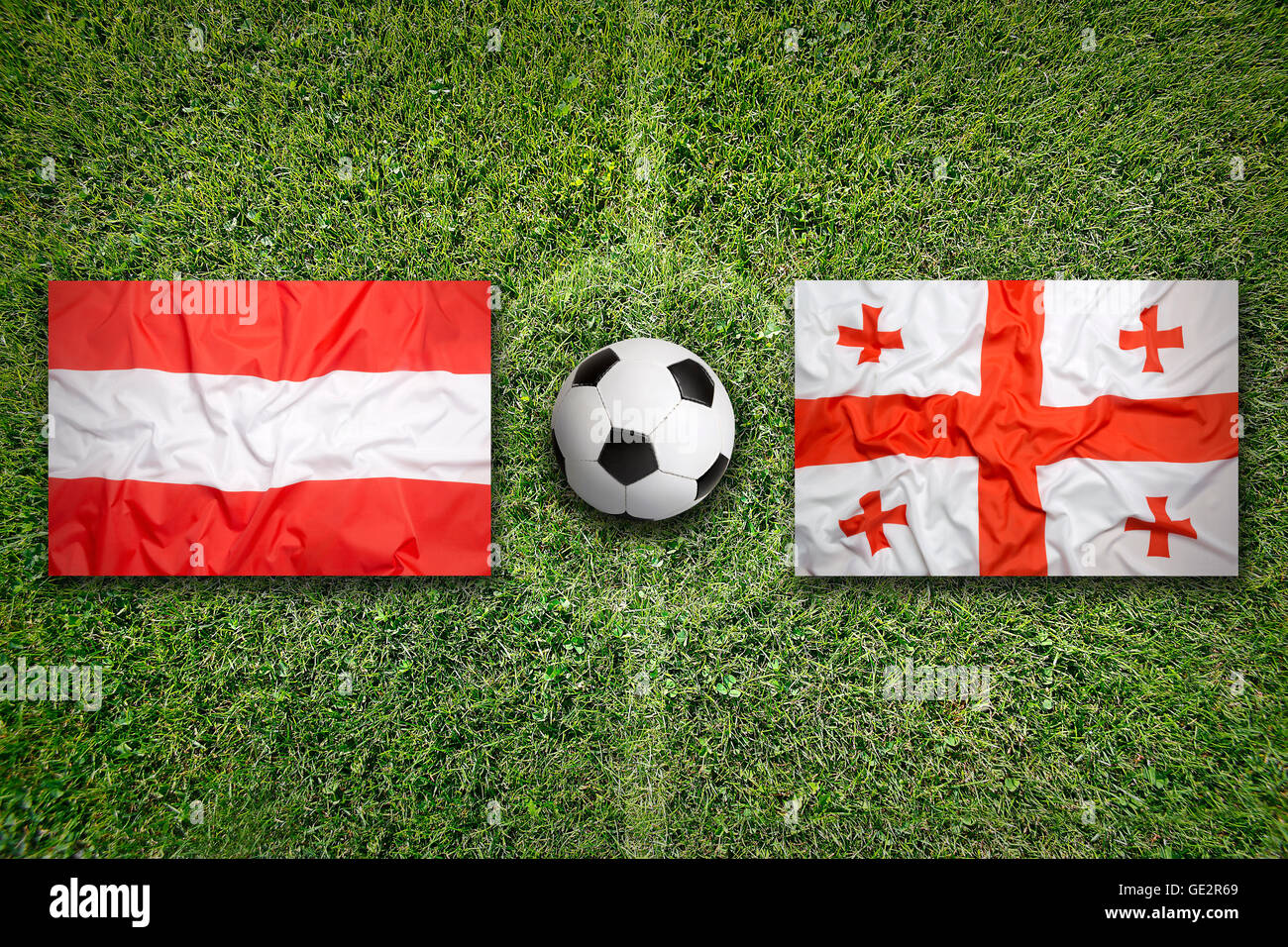 L'Autriche contre la Géorgie Les drapeaux sur le terrain de soccer vert Banque D'Images