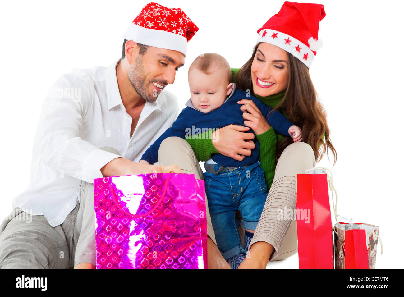 Heureux père et mère avec fils à la dans votre panier. Famille de trois sont wearing Santa hats. Ils célèbrent leur f Banque D'Images