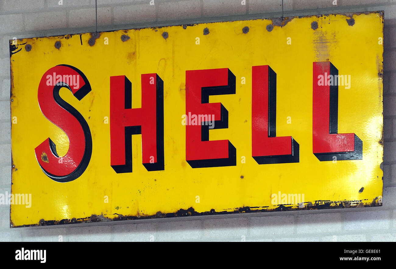 Une enseigne en émail vintage faisant la publicité Shell, une compagnie pétrolière bien connue. Ce panneau en émail reflète les techniques et le design publicitaires du milieu du XXe siècle. Banque D'Images
