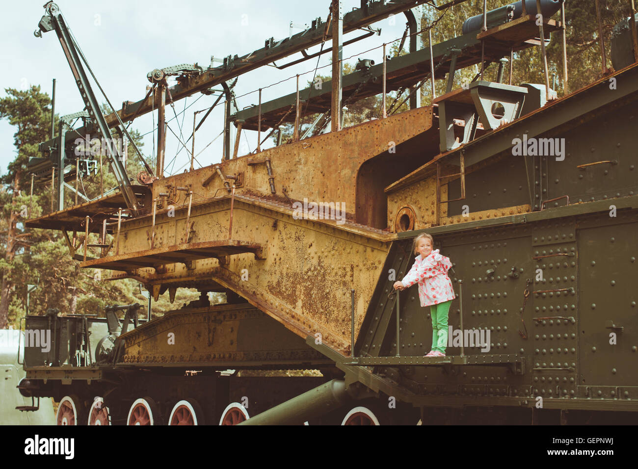 Fille dans un dossier rose sur un 305 mm sur l'installation TM-3-12-militaire site historique de Fort Krasnaya Gorka, Russie Banque D'Images