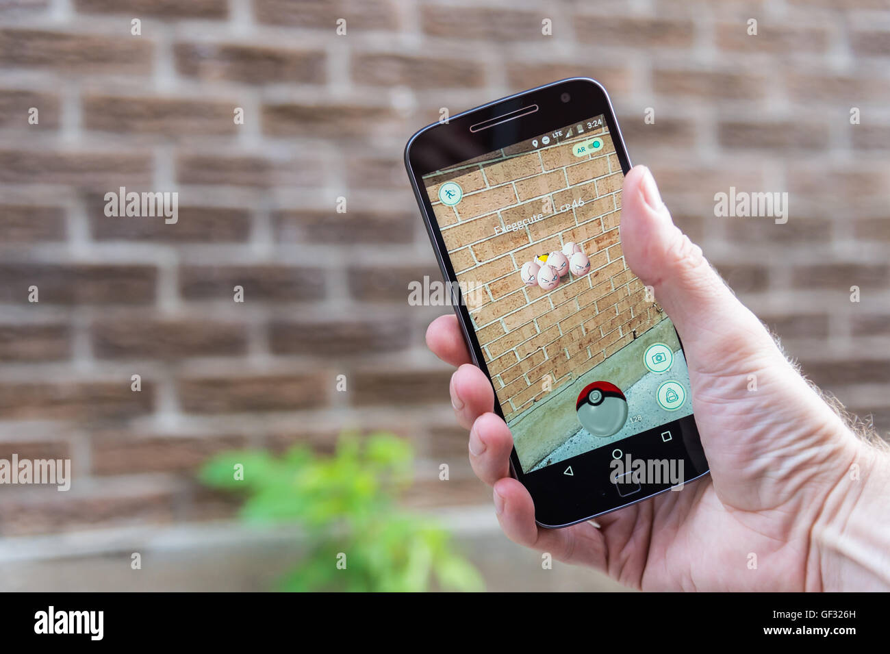 Montréal, CA - le 27 juillet 2016 : Libre d'un homme jouant de Pokemon rendez sur un téléphone intelligent. Pokemon Go est un jeu de réalité virtuelle de presse Banque D'Images