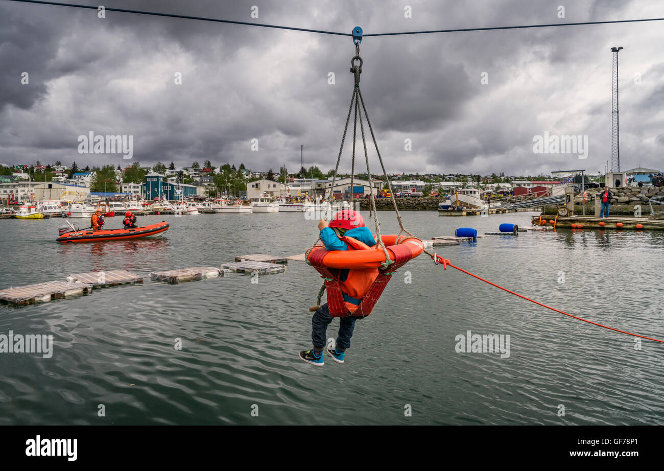 L'enfant sur une ceinture de sauvetage avec un conservateur de vie à l'Assemblée annuelle de Seaman's Festival, Hafnarfjordur, Islande Banque D'Images