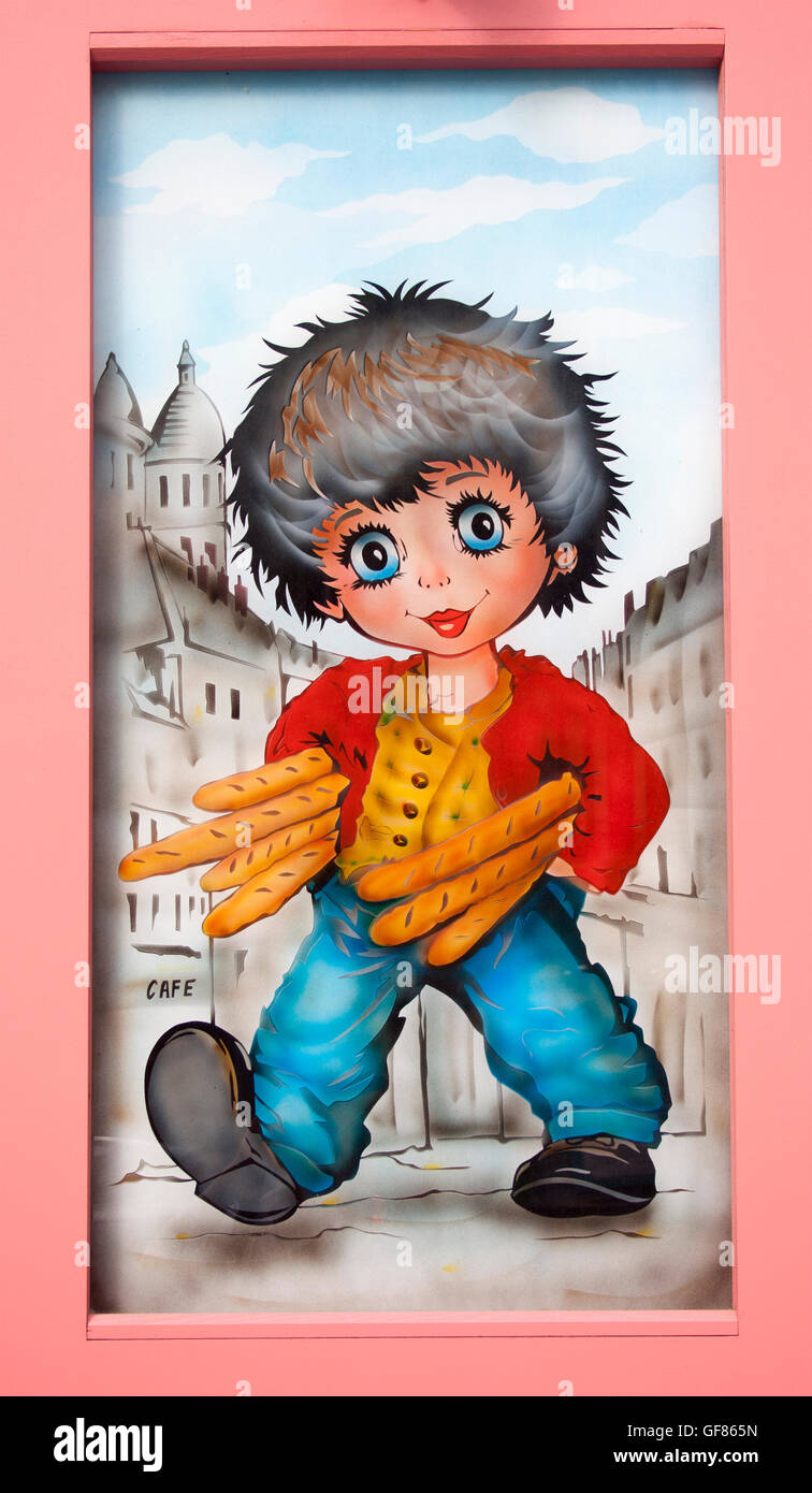 La charmante œuvre « Boy with baguettes » décore une boutique à Montmartre, Paris, ajoutant fantaisie aux rues artistiques du quartier. Banque D'Images