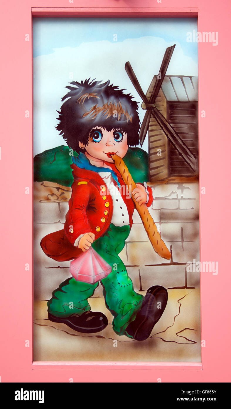 La charmante œuvre « Boy with baguettes » décore une boutique à Montmartre, Paris, ajoutant fantaisie aux rues artistiques du quartier. Banque D'Images