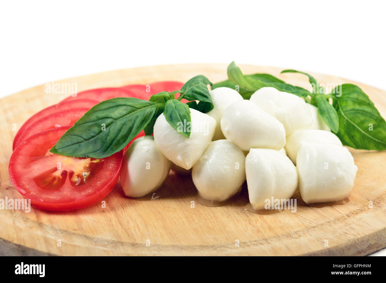 Des tranches de tomate et mozzarella avec des feuilles de basilic Banque D'Images