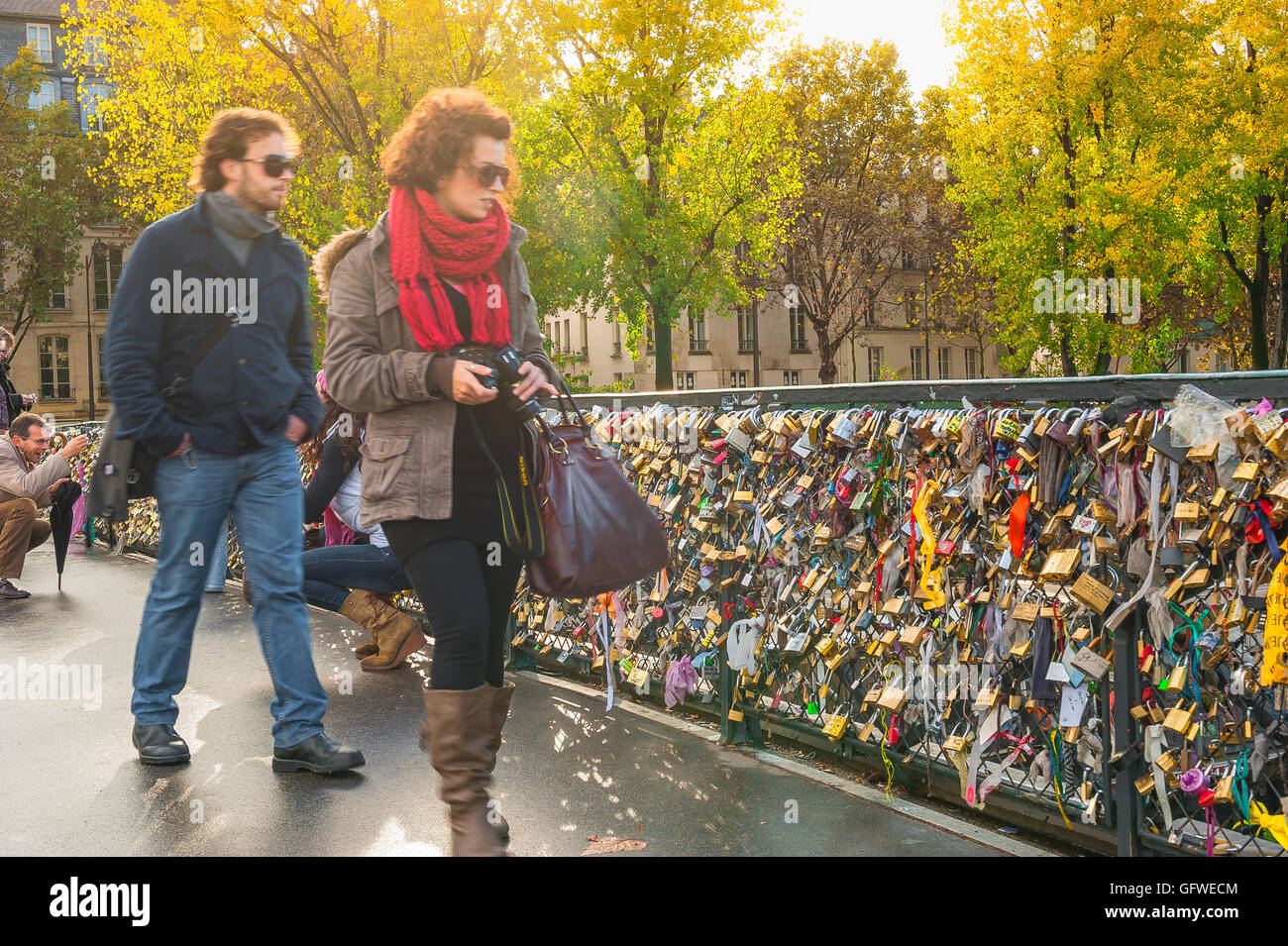 Couple pont de Paris, vue en automne de deux jeunes regardant des "locks d'amour" fixés au Pont de l'Archeveche, dans le centre de Paris, France Banque D'Images
