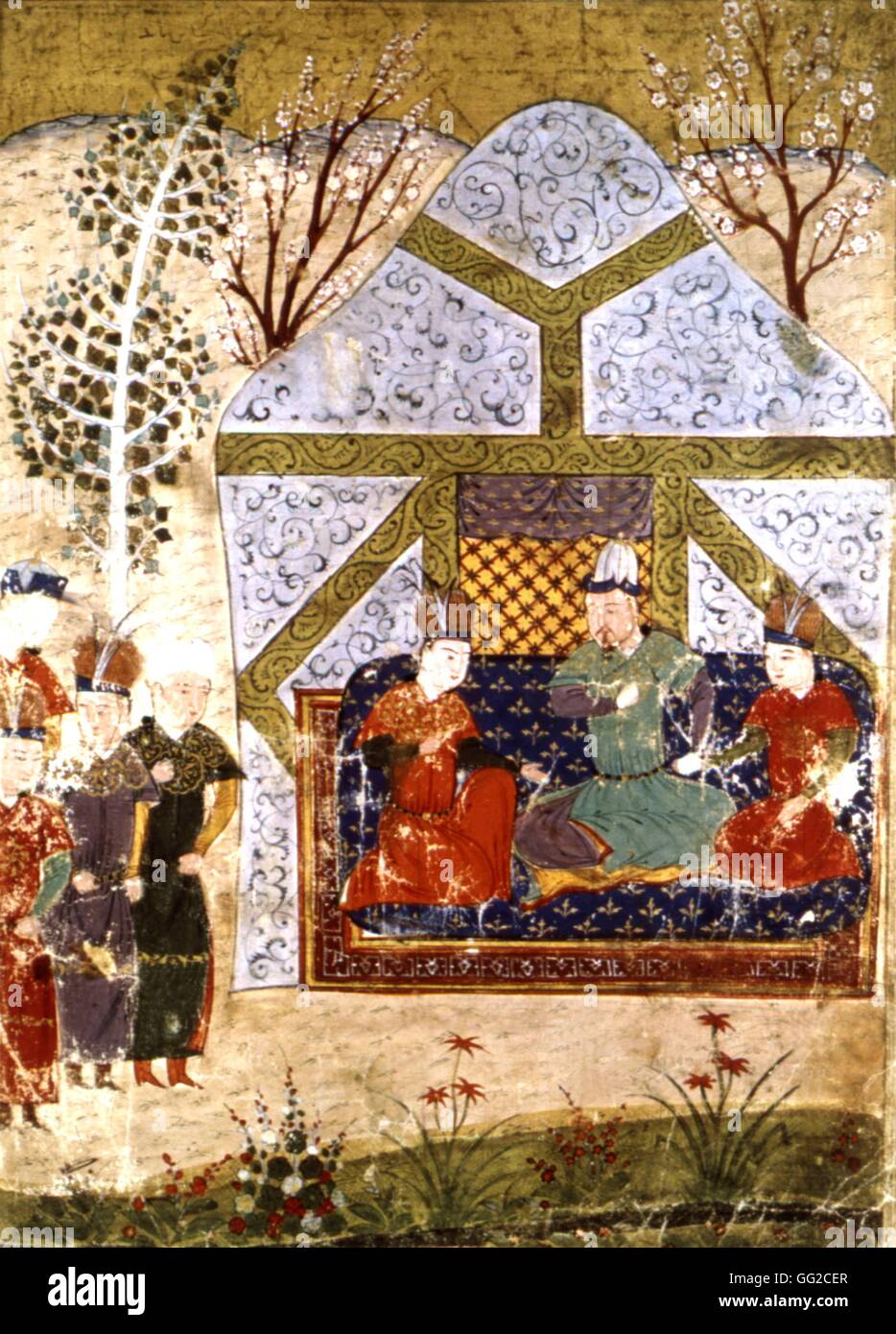 Manuscrit persan illustré de 106 tableaux : 'Jami'al Tawarikh" par Rachid ad-Dîn (Histoire des Mongols). Le troisième fils de Gengis Khan sur son trône, entouré de ses enfants. 14ème siècle de l'école persane Banque D'Images
