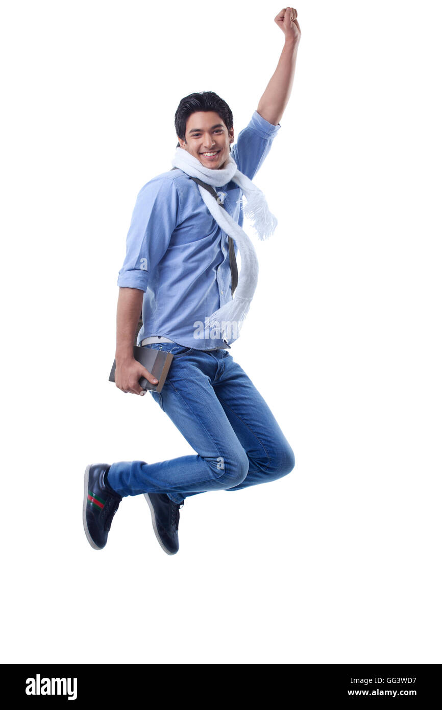 Portrait d'étudiant jumping over white background Banque D'Images