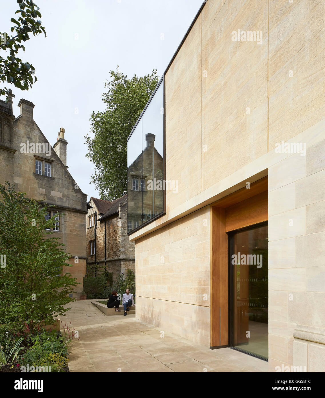 Façade en pierre extérieur le long de la perspective et de vitrage. Le jardin des capacités au Lincoln College, Oxford, Royaume-Uni. Architecte : Stanton Williams, 2015. Banque D'Images