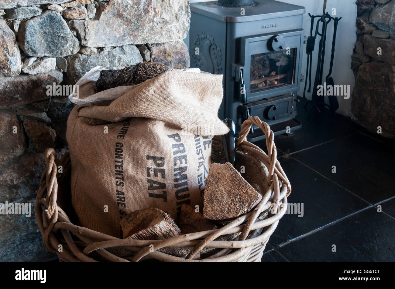 Sac de tourbe dans une maison à Outer Hebrides pour utilisation comme carburant dans poêle à bois Morsø en arrière-plan. Banque D'Images