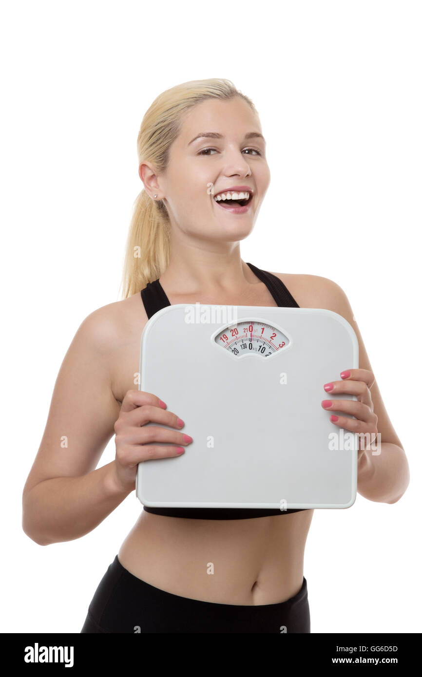 Happy woman holding fitness pèse-personne Banque D'Images