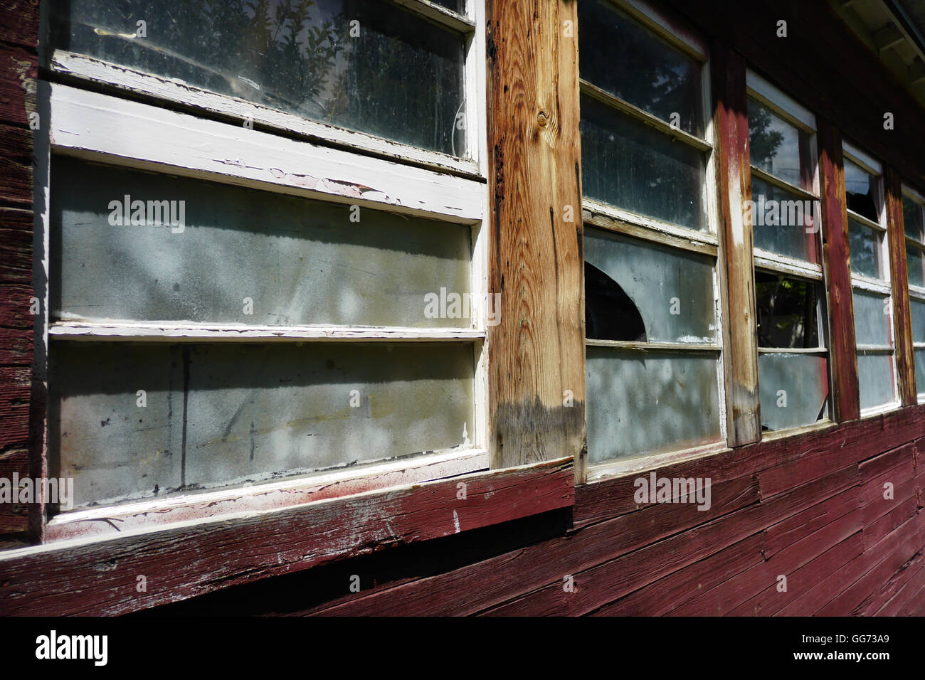 Vitres brisées sur le côté d'une vieille grange en bois dans les régions rurales du Nord. Banque D'Images