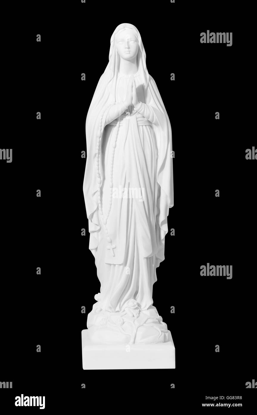 Statue d'une jeune femme religieuse priant isolé sur un fond noir Banque D'Images
