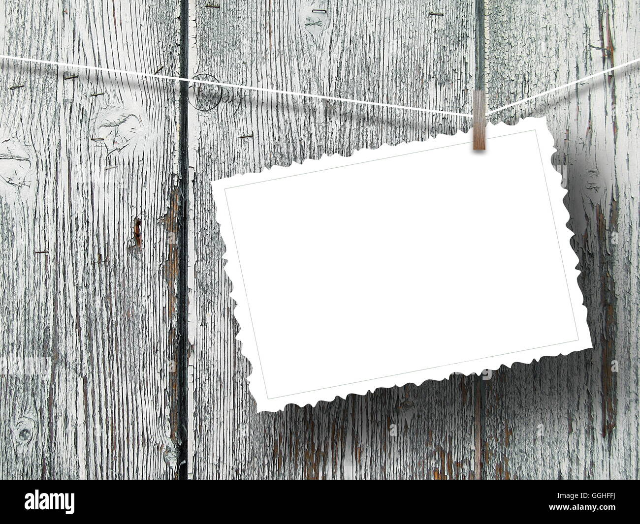 Close-up d'un cadre de carte postale vierge pendus par indexation sur fond en bois gris Banque D'Images