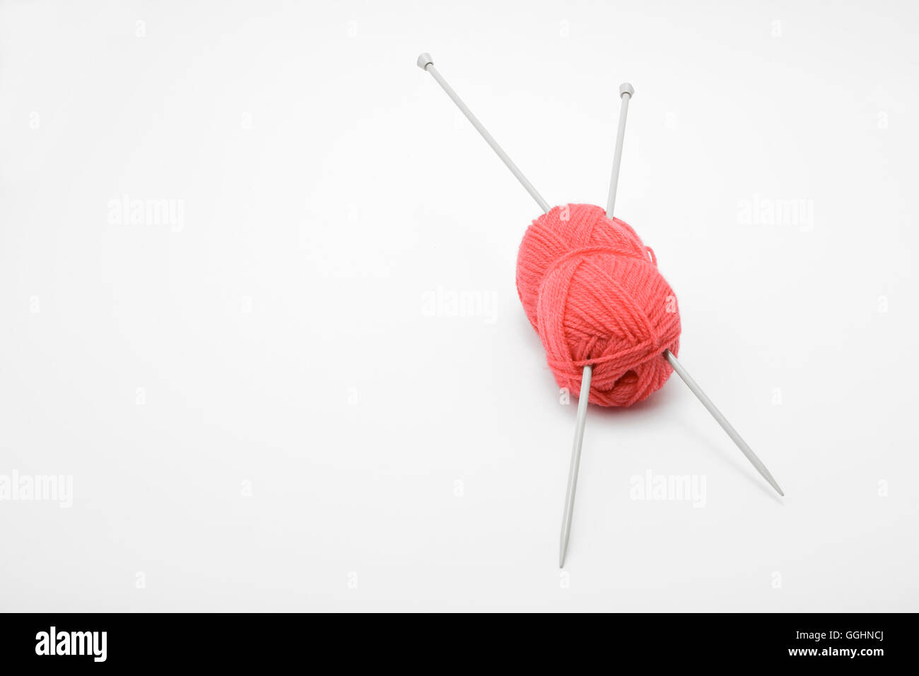 Aiguilles à tricoter et boules de laine rose Banque D'Images