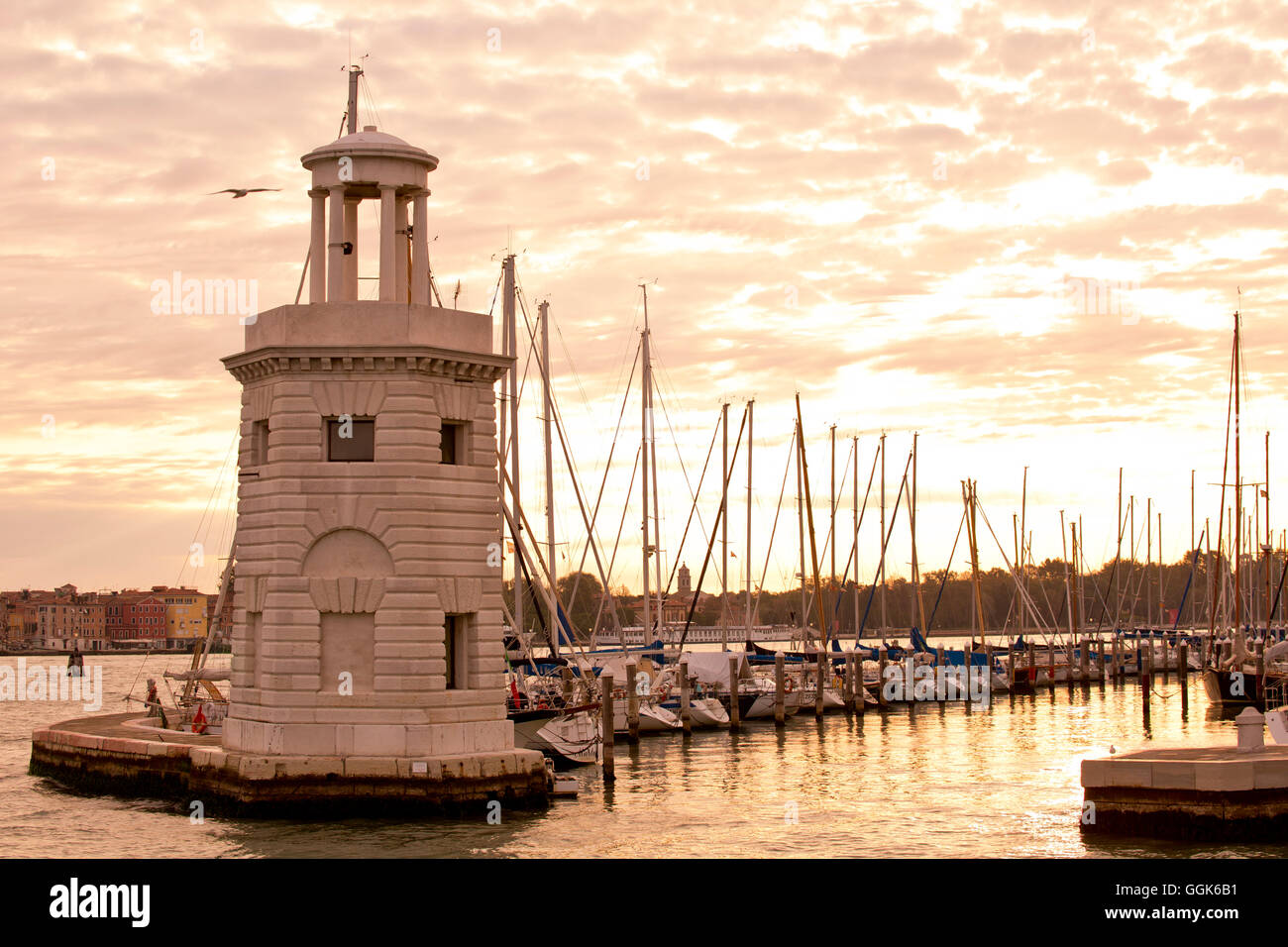 Petit phare à l'entrée de la marina, sur l'Isola di San Giorgo Maggiore island le long de Bacino di San Marco au lever du soleil, Veni Banque D'Images