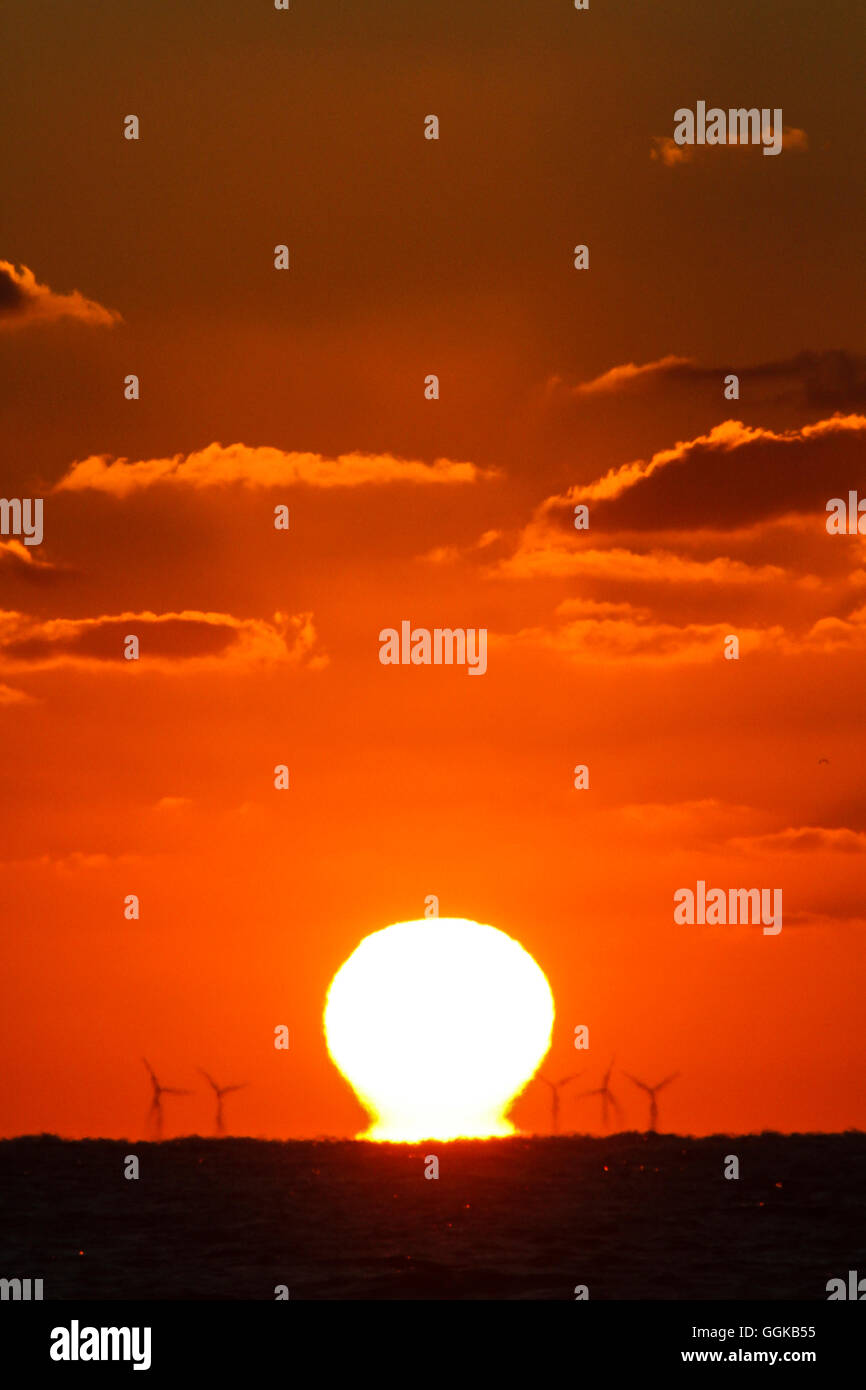 Coucher de soleil derrière les moteurs à vent, mer du Nord, Allemagne Banque D'Images