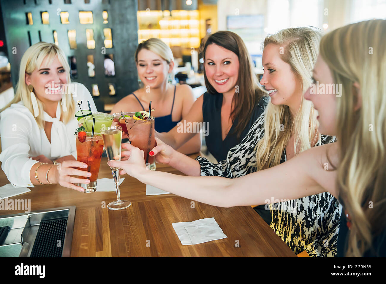 Caucasian women toasting at bar à cocktails Banque D'Images