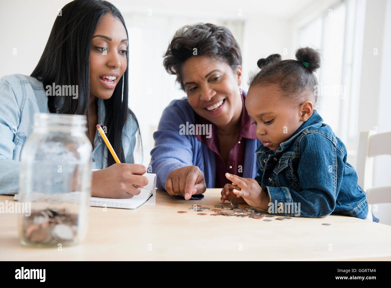 Black multi-generation family à compter des pièces Banque D'Images