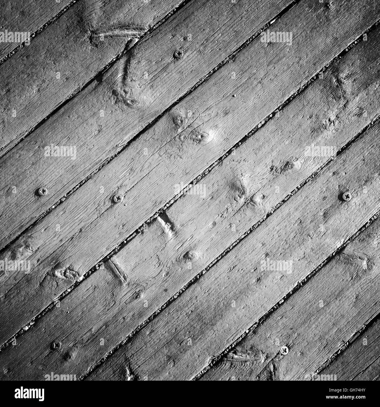 Vieux plancher en bois gris avec des vis, la texture de fond photo détaillée Banque D'Images