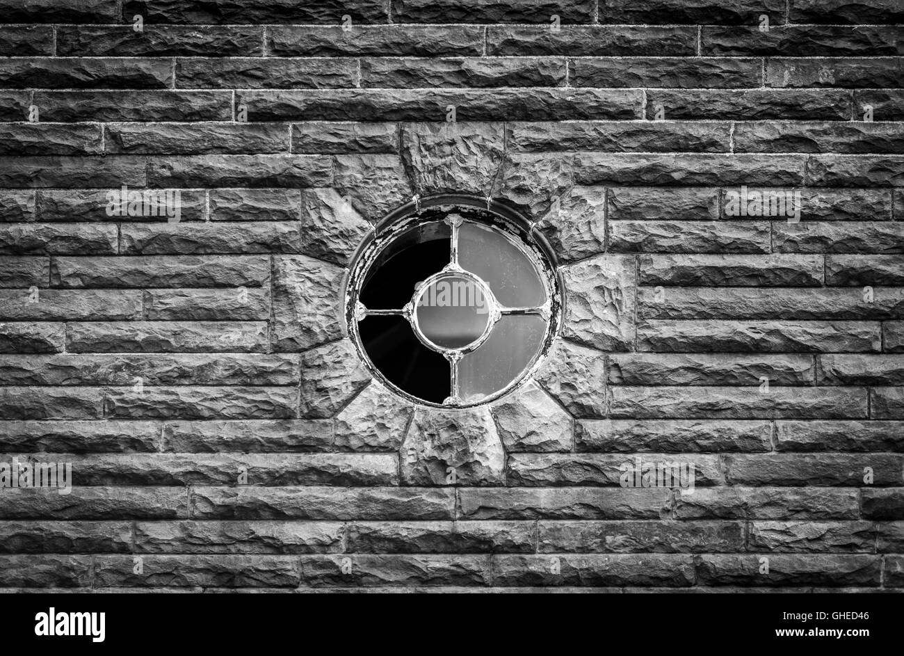 Fenêtre ronde dans le vieux mur de maçonnerie Banque D'Images