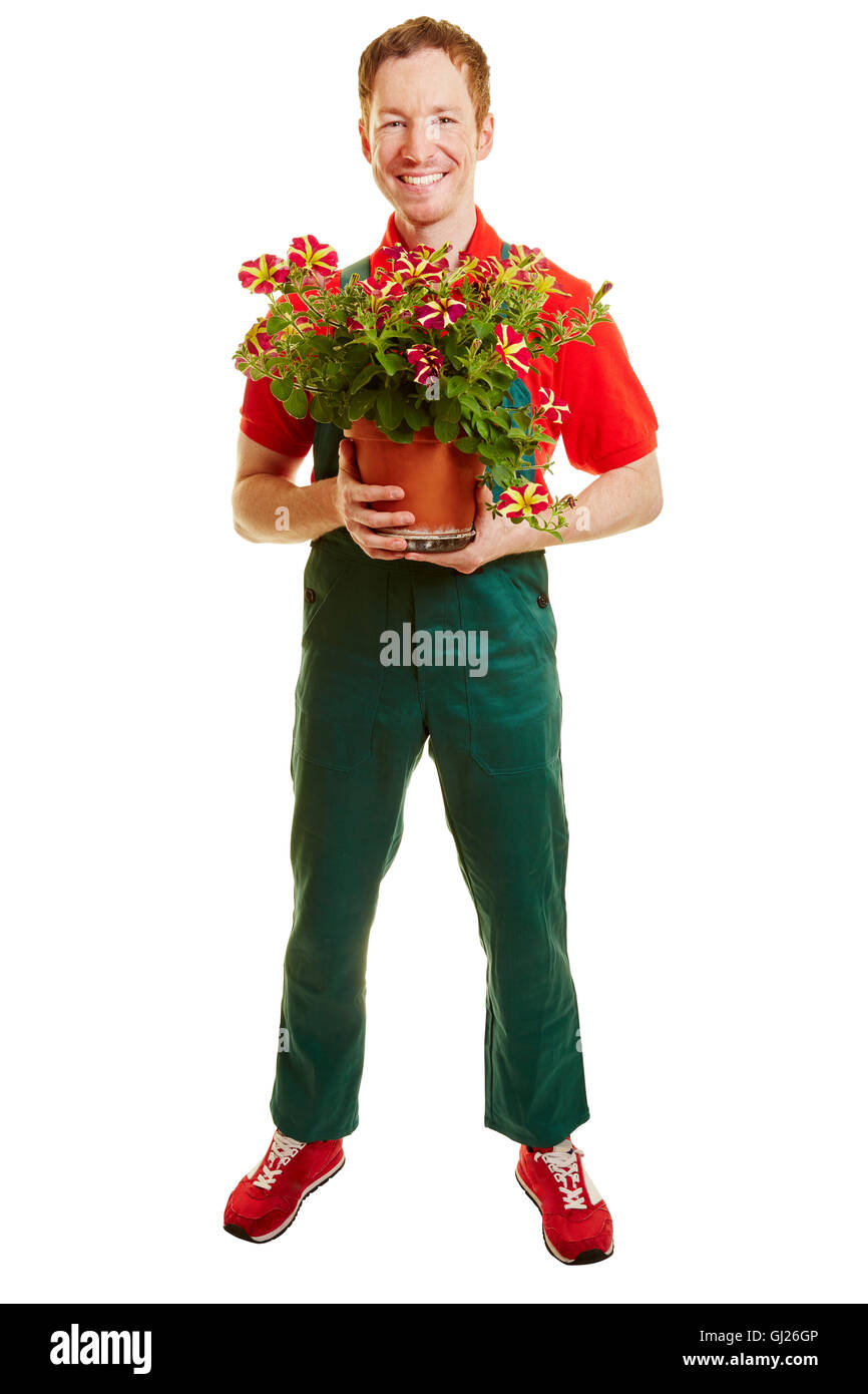 Un fleuriste avec un ensemble vert tenant un pot de fleurs sur ses mains Banque D'Images