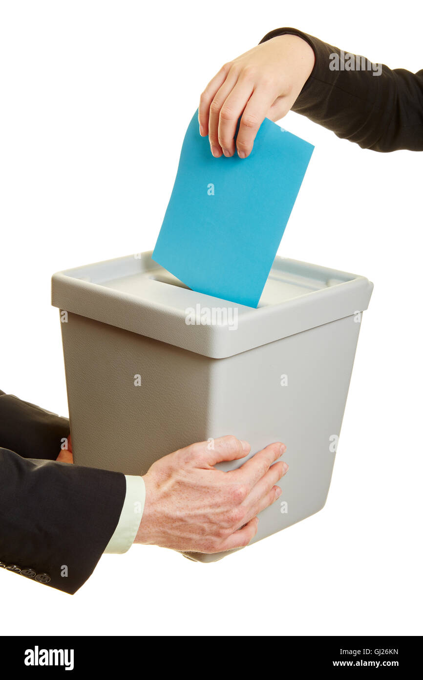 Mains de gens d'affaires l'introduction d'un bulletin de vote dans l'urne Banque D'Images