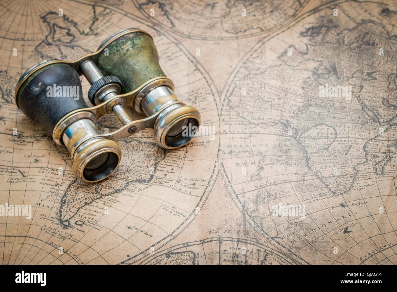 Paire de jumelles anciennes vintage sur une carte du monde, ce qui suggère l'exploration ou de voyage Banque D'Images