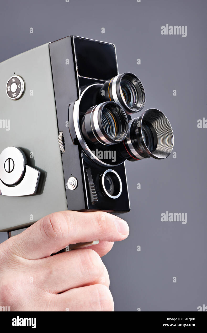 Passe-temps mécanique rétro film appareil photo dans les mains de l'opérateur gris isolé Banque D'Images