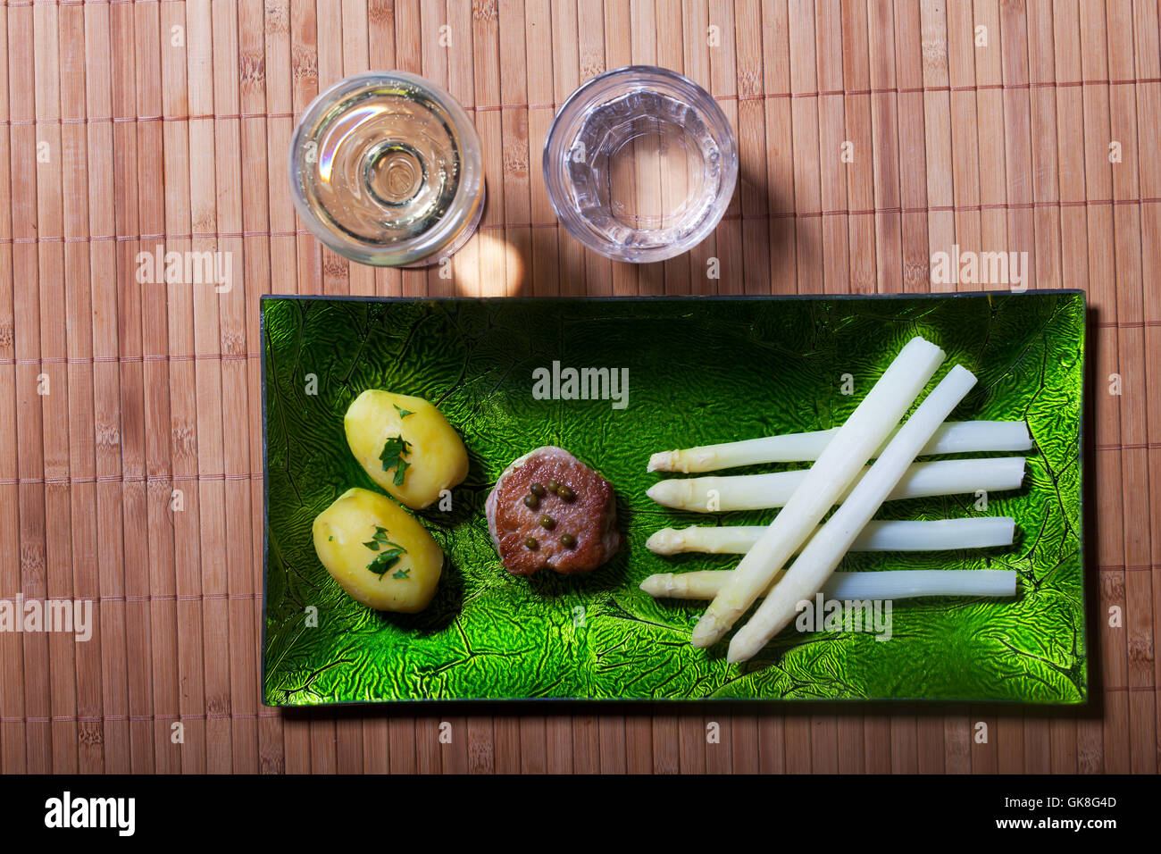 Peler les asperges blanches sur une plaque verte Banque D'Images