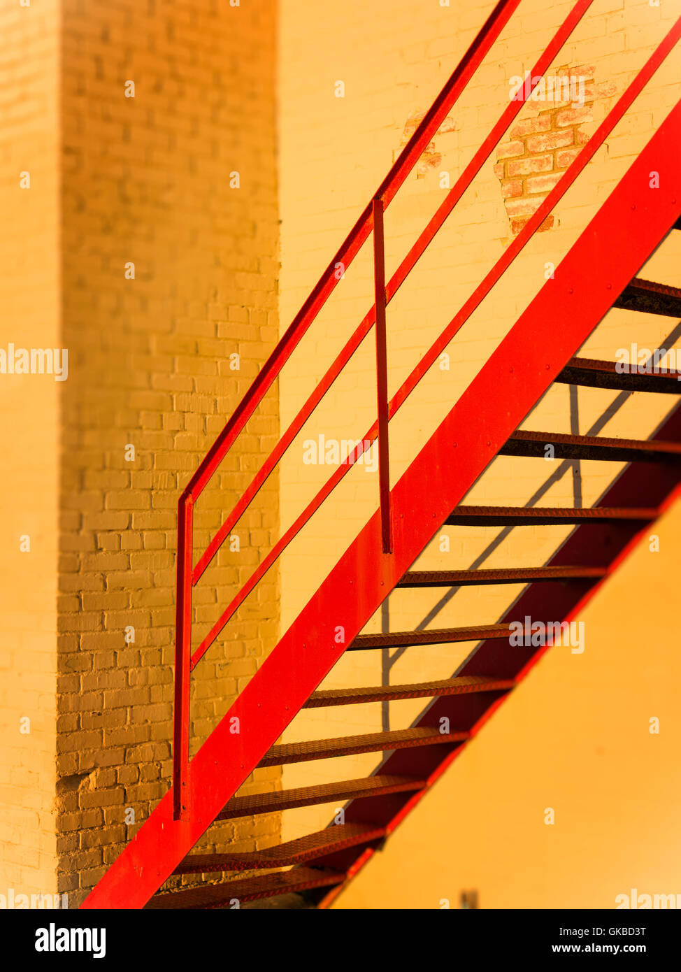 L'escalier rouge contre les briques peints en jaune au cours de la 'Golden Hour', Virginia Beach, VA Banque D'Images