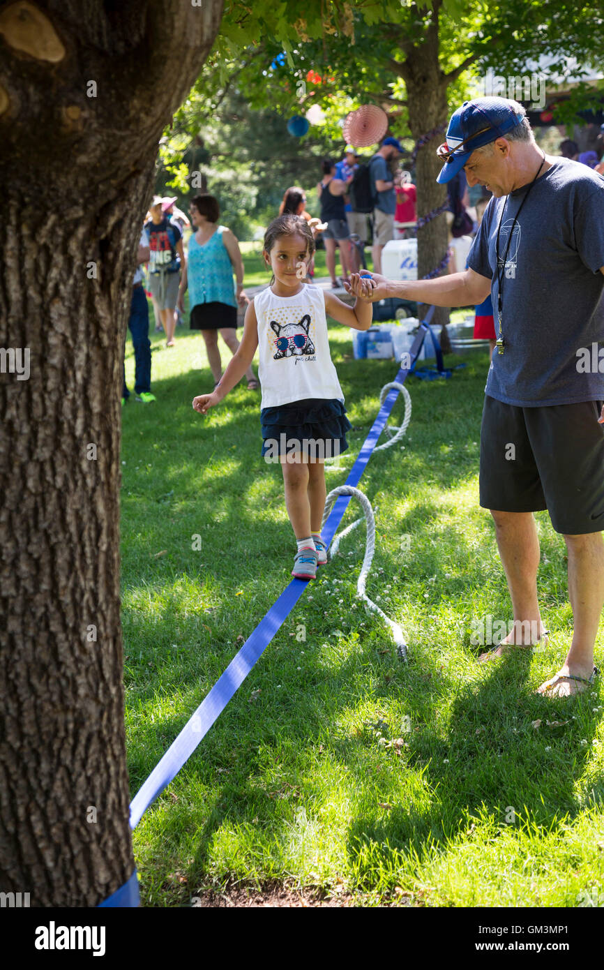 Aspen, Colorado - Une fille marche sur une slackline lors d'un pique-nique et défilé le 4 juillet dans la banlieue de Denver. Banque D'Images