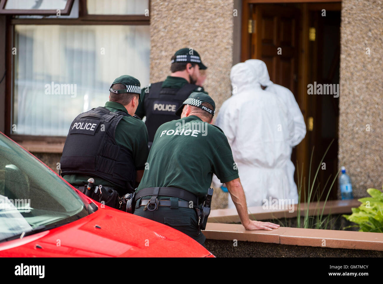 Les officiers de l'armée et PSNI agents techniques de recherche sur l'ancienne route Glenarm dans Larne, Co Antrim, comme Royal Marine est remis en question par des détectives enquête sur le terrorisme lié à l'Irlande du Nord, c'est connecté à deux grands bras républicain dissident trouve. Banque D'Images