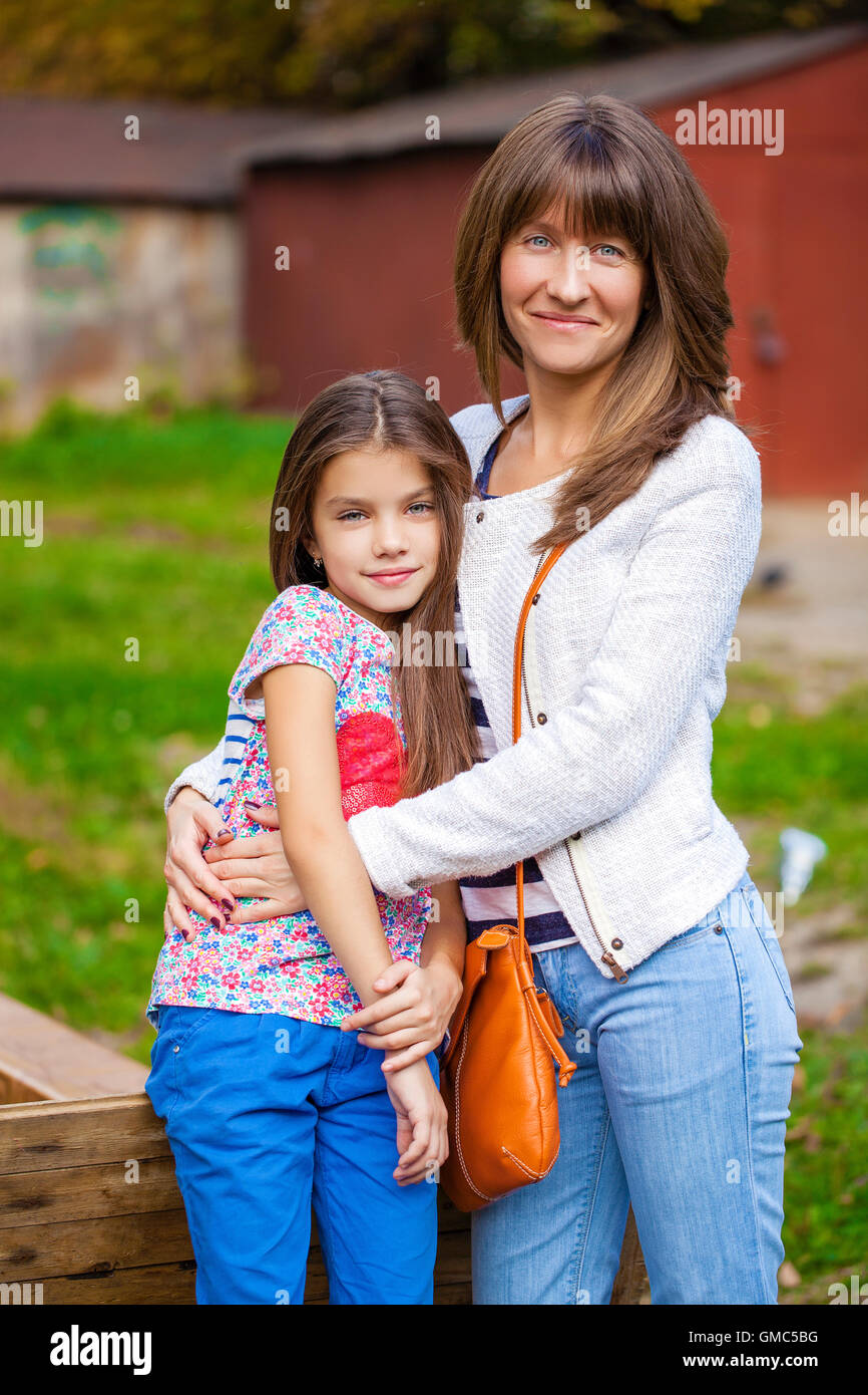 Portrait d'une belle petite fille de neuf ans et heureuse mère in autumn park Banque D'Images