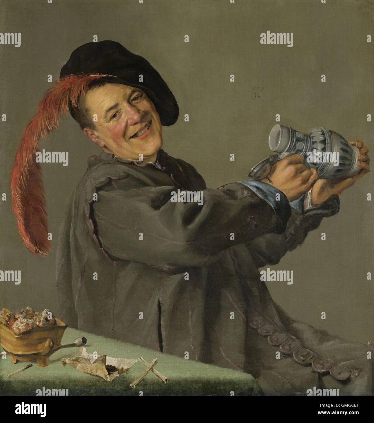 Le joyeux buveur, par Judith Leyster, 1629, la peinture hollandaise, huile sur toile. A smiling man lève son tankard, assis à une Banque D'Images Le joyeux buveur, par Judith Leyster, 1629, la peinture hollandaise, huile sur toile. A smiling man lève son tankard, assis à une Banque D'Images