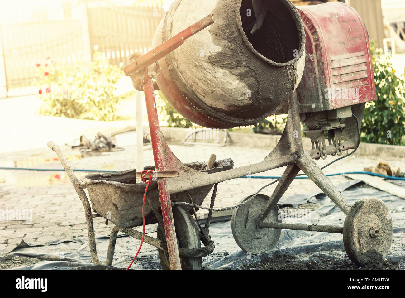 Bétonnière rouge déménagement les composants du béton dans la lumière de soleil merveilleux Banque D'Images