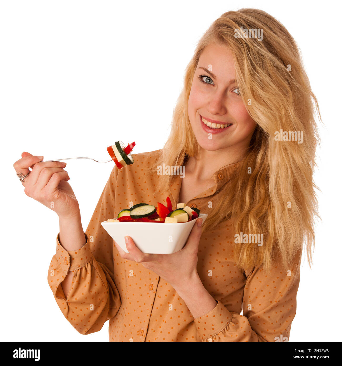 Très belle jeune femme blonde caucasienne mange une délicieuse salade comme un signe de saine alimentation isolated over white Banque D'Images
