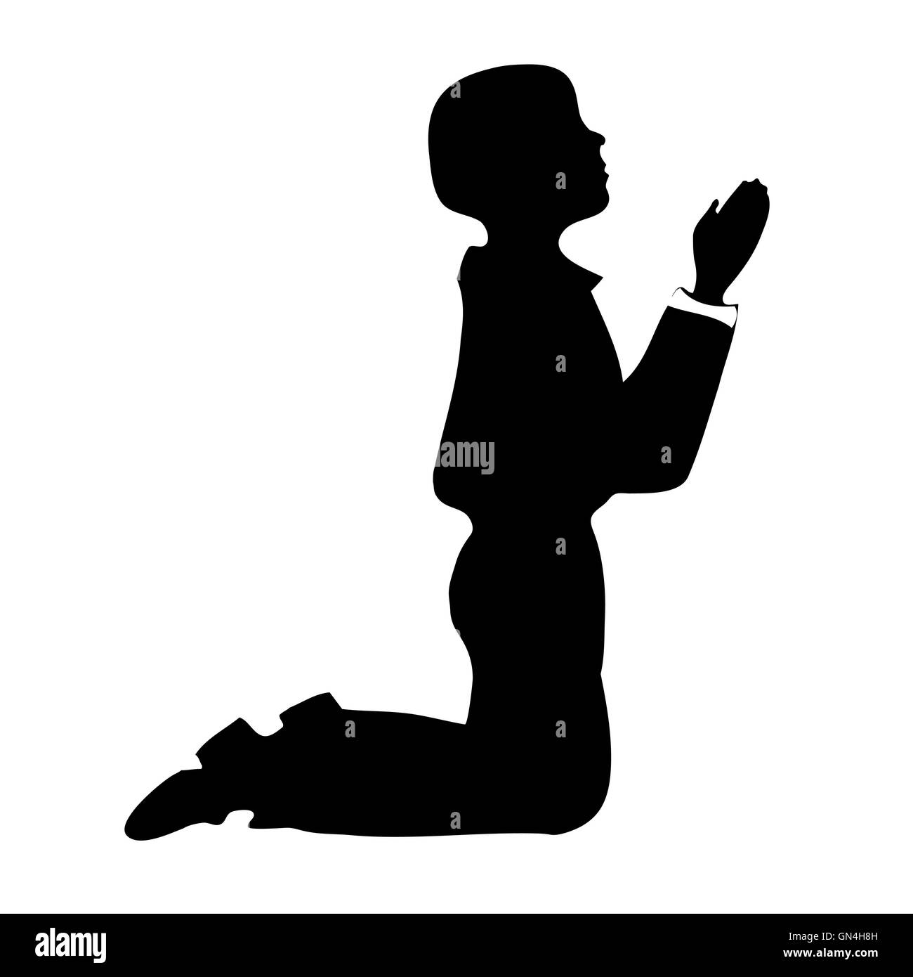 Silhouette garçon priant Banque D'Images
