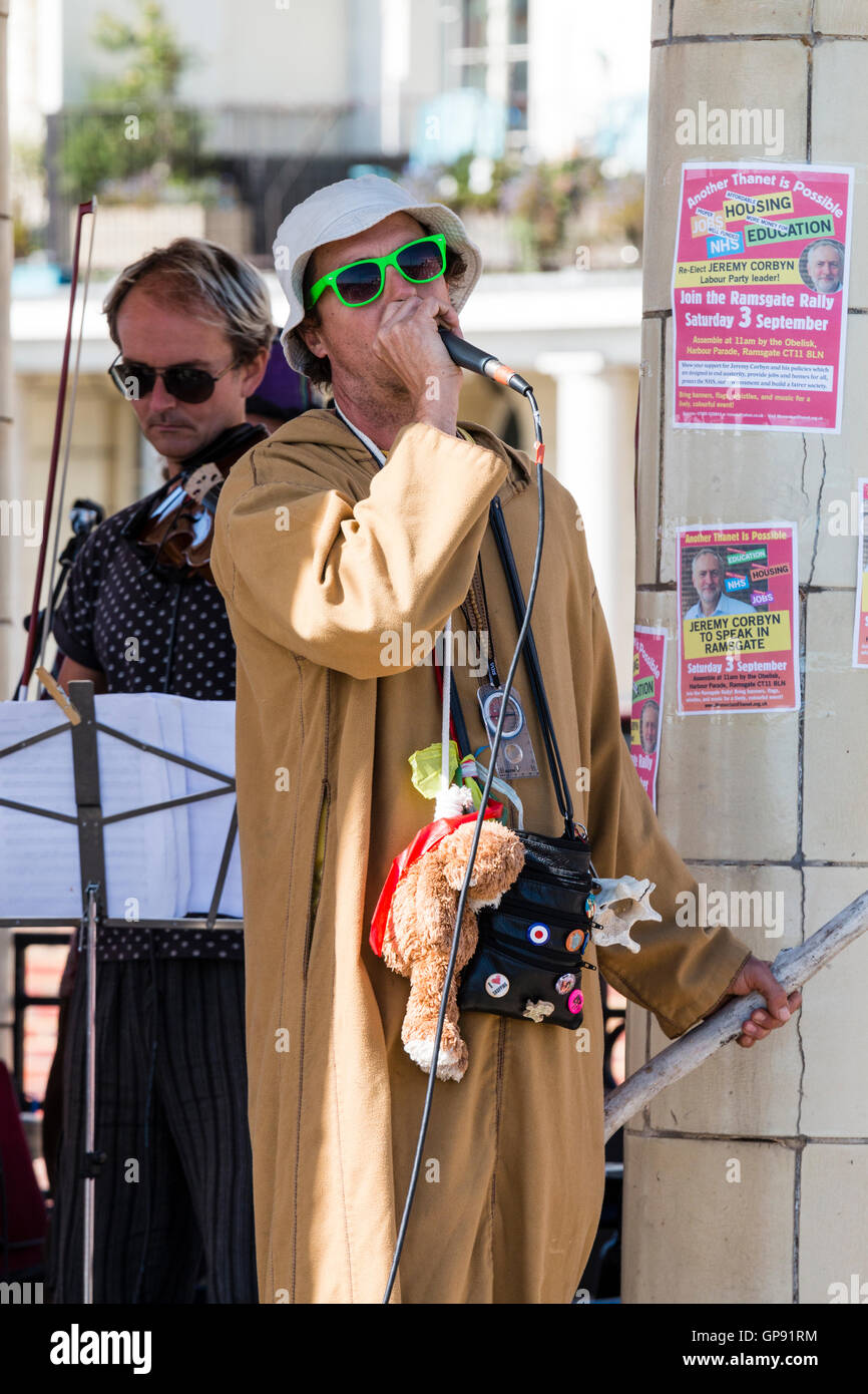 L'Angleterre, Ramsgate. Chanteur politique blanc avec chapeau, lunettes et  long brown smock, le chant au rallye en plein air au soleil Photo Stock -  Alamy
