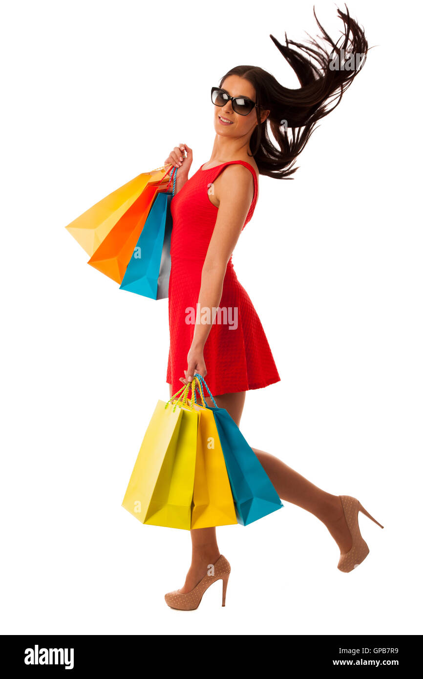 Beau young woman with shopping bags isolated over white background Banque D'Images