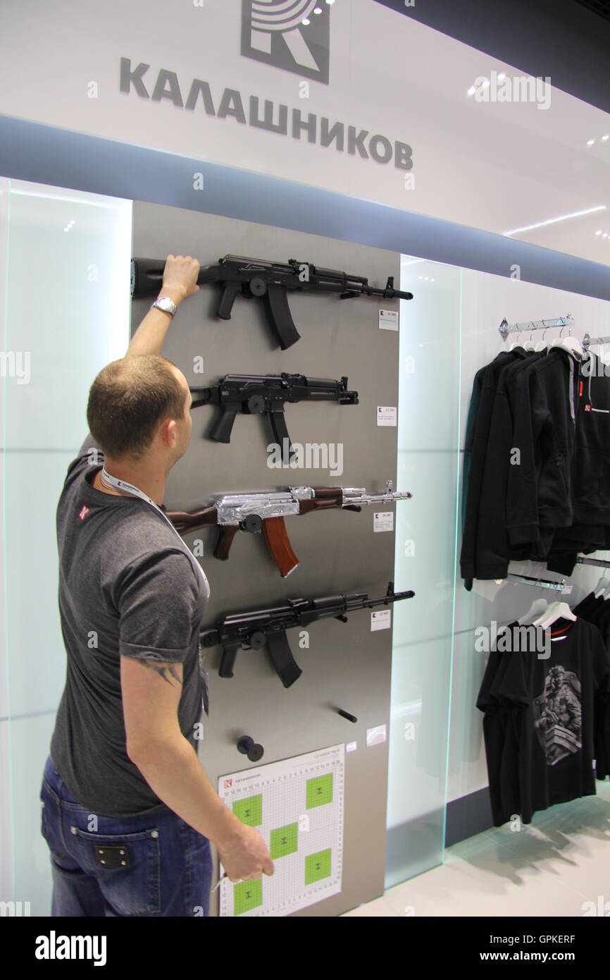 Moscou, Russie. Août 26, 2016. Un vendeur présente un faux fusil d'assaut Kalachnikov AK-47 lors d'une boutique à l'Aéroport de Sheremetyevo à Moscou, Russie, le 26 août 2016. Dans le magasin, l'entreprise propose des vêtements et accessoires aussi alongise réplique fidèle d'armes de l'AK-47 classique arme. La Russie est kalachnikov plus grand producteur mondial d'armes utilisées dans le monde entier. Mais il y a des fusils réels disponibles dans la boutique de souvenirs. Cependant T-shirts avec le logo de l'entreprise et les vêtements de plein air chaud avec motif de camouflage sont disponibles. Photo : Thomas Koerbel/dpa/Alamy Live News Banque D'Images